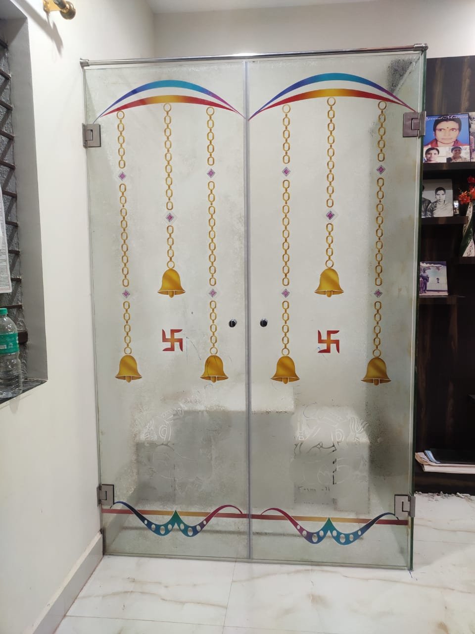 Frameless pooja glass door with printed bells