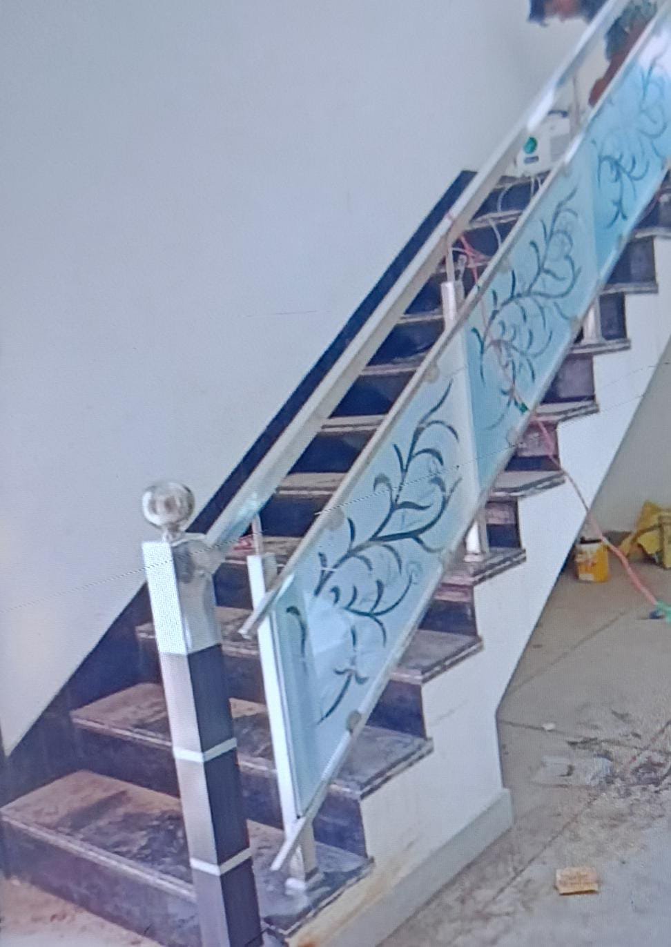 Etched tree design on staircase railing glass